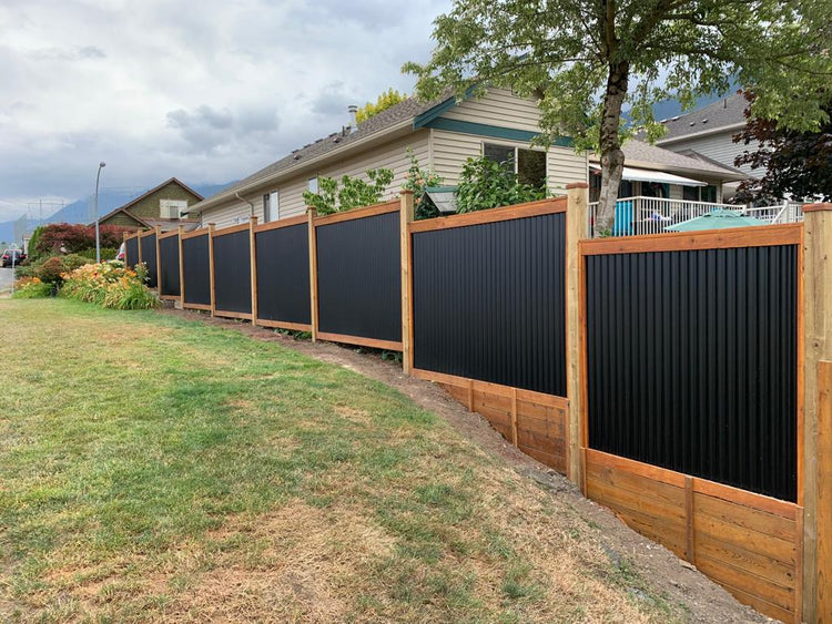 terraced black corrugated metal fence with wood frame