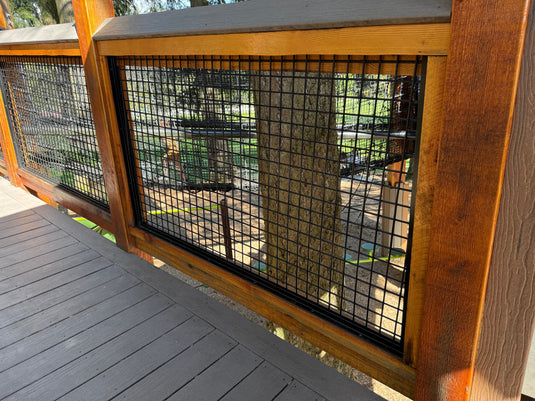 Cattle-style wire panel framed in cedar used as a porch railing