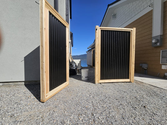 Modern backyard with black corrugated steel gate kit installed