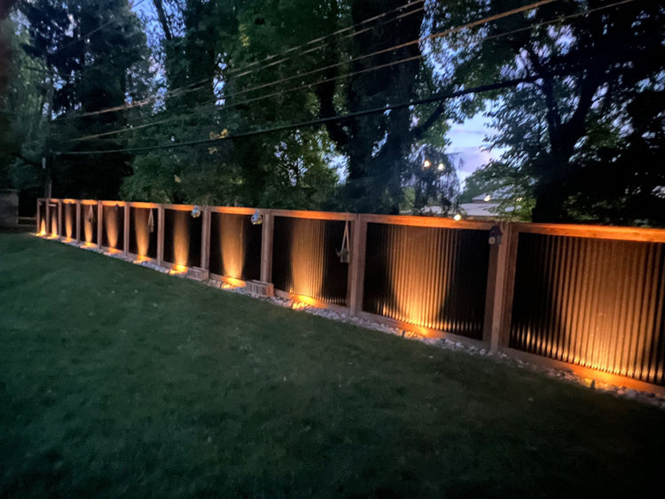 Black corrugated metal fences with Halloween themed lighting