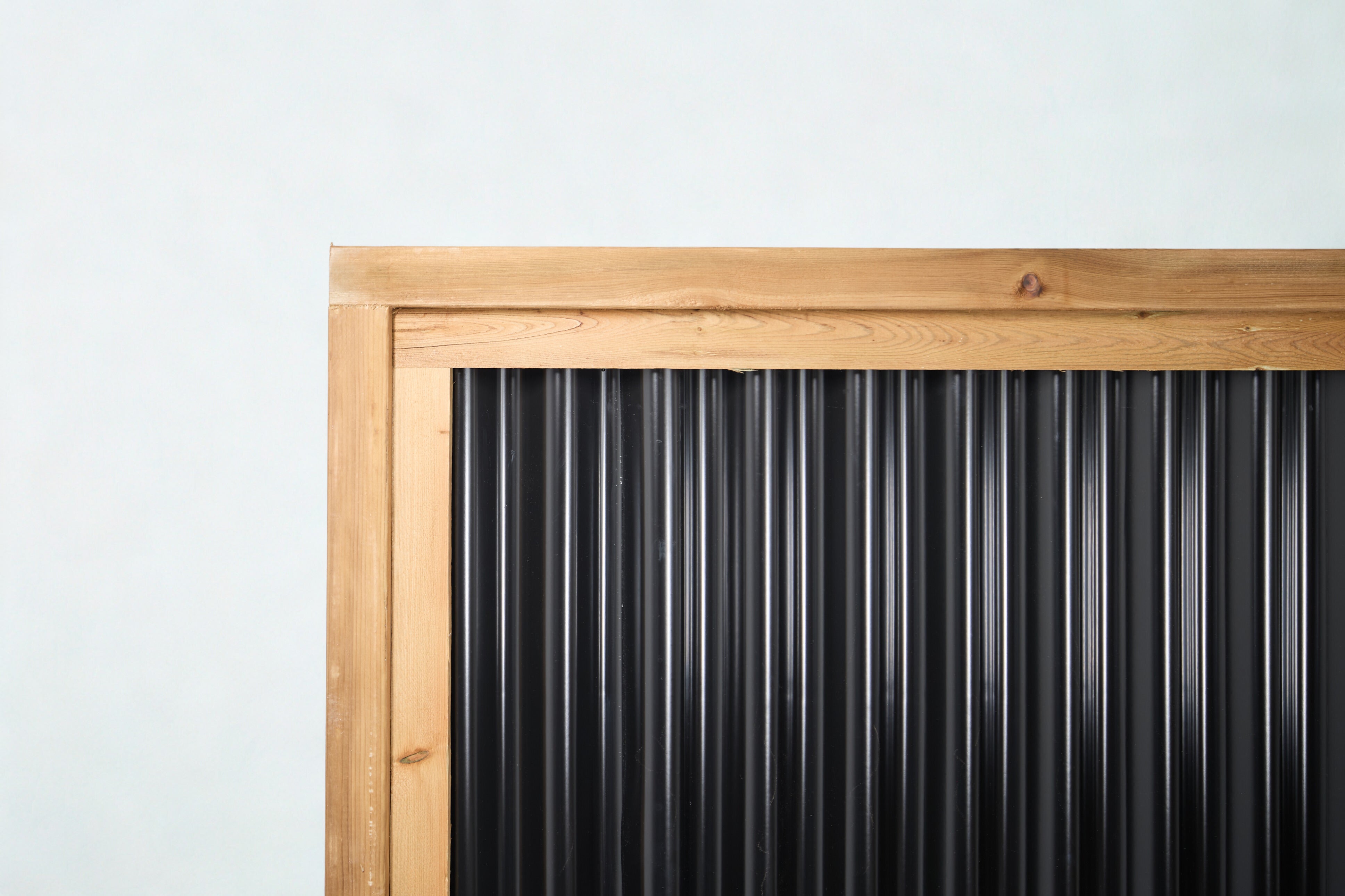 The Coastal corrugated metal fence panel, pressure treated frame   BarrierBoss Canada