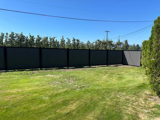 Zero maintenance corrugated metal fence panels with steel post and frame system.