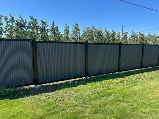 Zero maintenance corrugated metal fence panels with steel post and frame system.