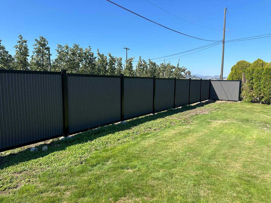 Zero maintenance corrugated metal fence panels with steel post and frame system.