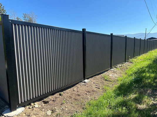 Zero maintenance corrugated metal fence panels with steel post and frame system.